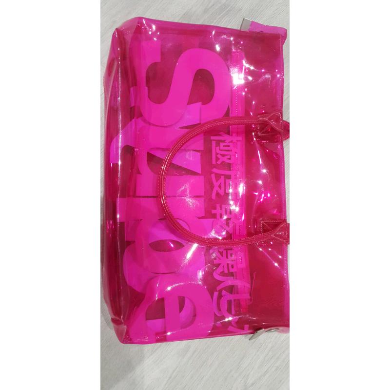 Neon pink transparent plastic Superdry bag
