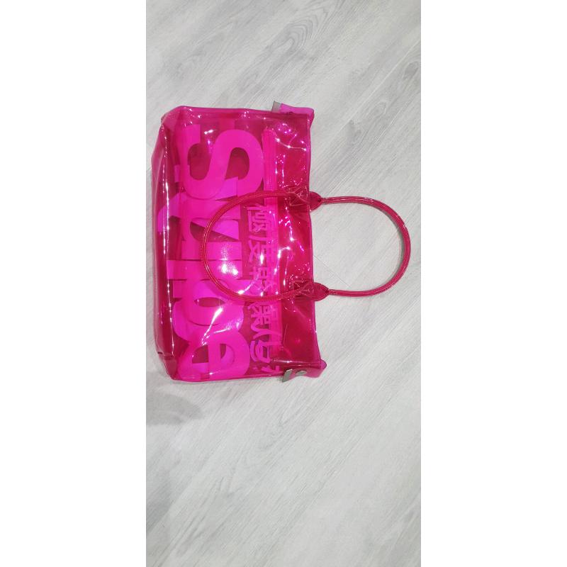Neon pink transparent plastic Superdry bag