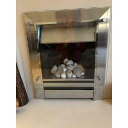 Solid stone mantelpiece with gas pebble effect fire