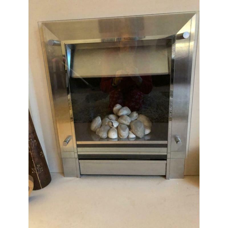 Solid stone mantelpiece with gas pebble effect fire